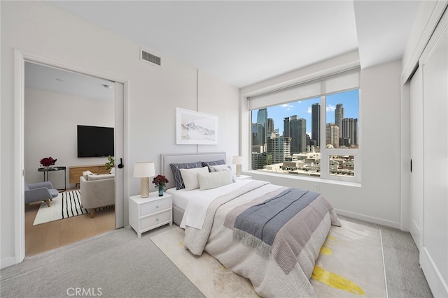 bedroom featuring light colored carpet