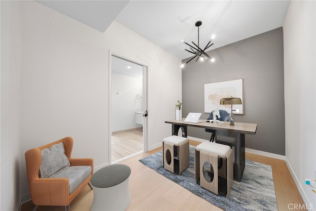 office space featuring light hardwood / wood-style flooring and an inviting chandelier