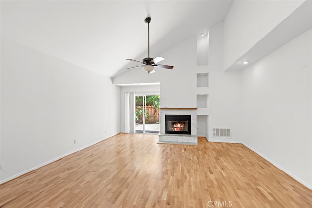 unfurnished living room featuring high vaulted ceiling, ceiling fan, and light wood-type flooring