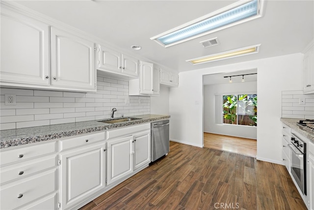 1585 Catalina, Laguna Beach, CA 92651 - kitchen with stainless steel appliances, a sink, decorative backsplash, and white cabinets