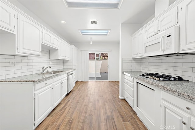 1585 Catalina, Laguna Beach, CA 92651 - kitchen featuring appliances with stainless steel finishes, a sink, white cabinetry, backsplash, and recessed lighting