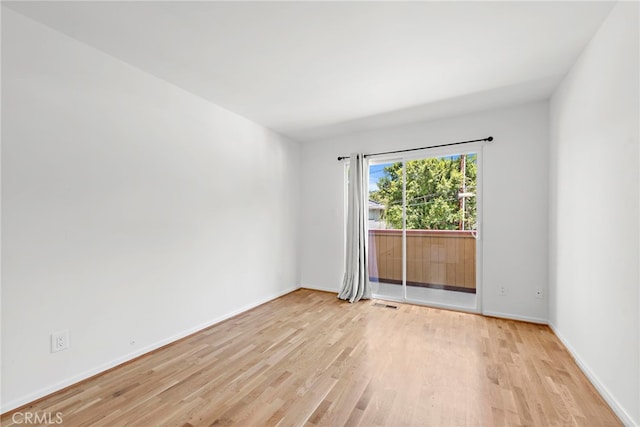 unfurnished room with light wood-type flooring