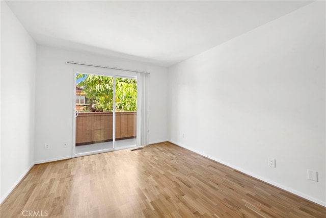 unfurnished room with light hardwood / wood-style flooring