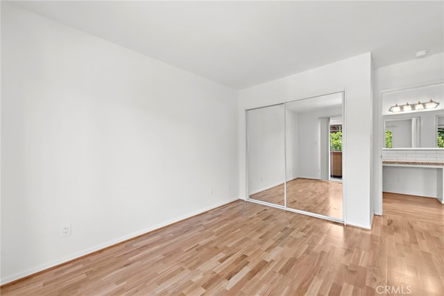 1585 Catalina, Laguna Beach, CA 92651 - unfurnished bedroom with light wood finished floors, a closet, and baseboards