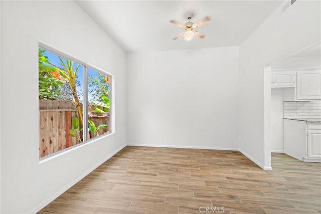 unfurnished room with ceiling fan and light hardwood / wood-style floors