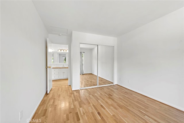 unfurnished bedroom featuring light hardwood / wood-style floors and a closet