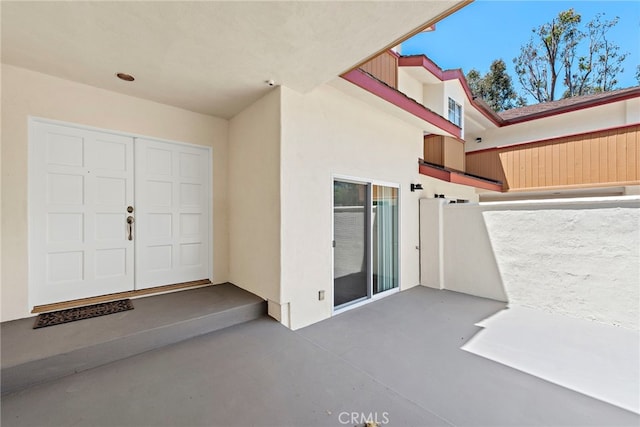 doorway to property featuring a patio area