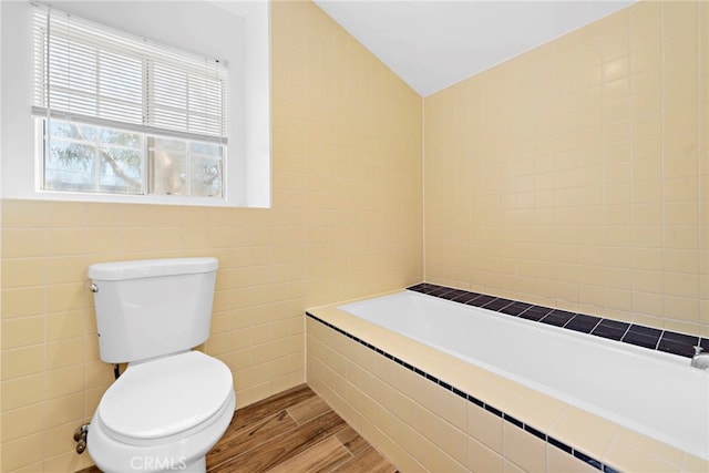 bathroom with tile walls, toilet, radiator, and hardwood / wood-style flooring