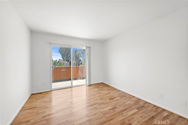 spare room with light hardwood / wood-style flooring