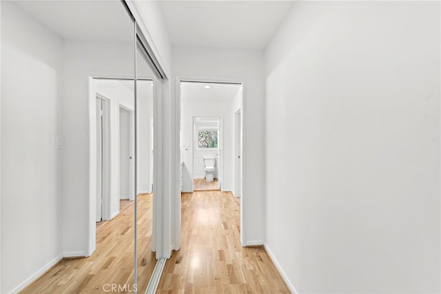 hall with light hardwood / wood-style floors