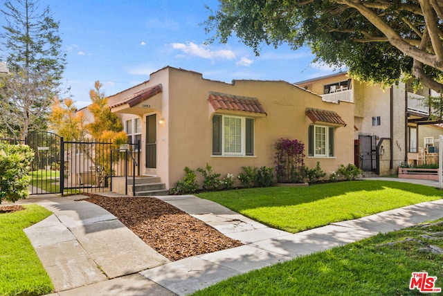 mediterranean / spanish home featuring a front yard