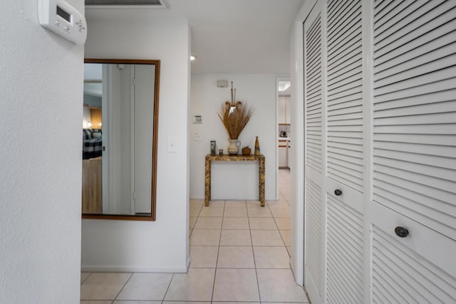 hall with light tile patterned floors