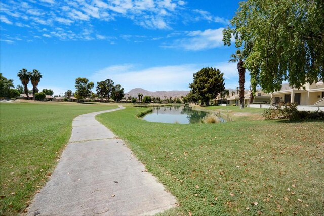 view of community featuring a yard and a water and mountain view