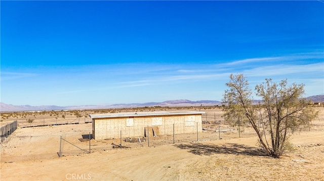 view of outbuilding featuring a rural view and a mountain view