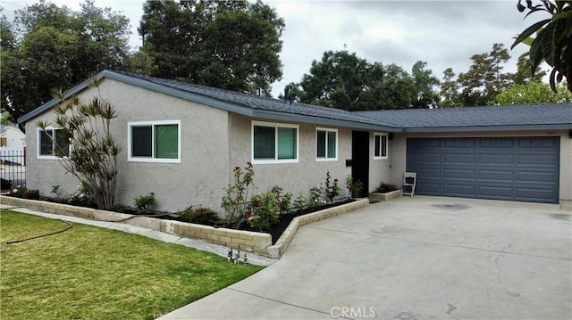 ranch-style home featuring a garage and a front yard