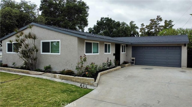 ranch-style home featuring a garage and a front yard