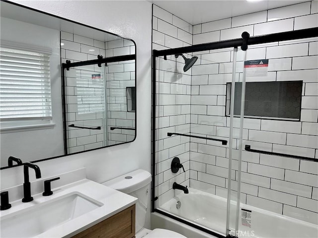 full bathroom with shower / bath combination with glass door, vanity, and toilet