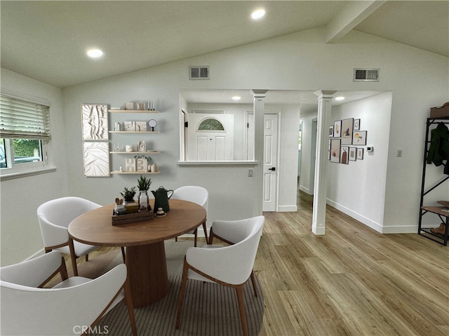 dining space with lofted ceiling with beams and light wood-type flooring