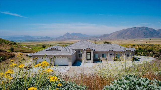 view of front of property with a mountain view and a garage