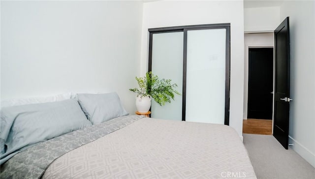 bedroom featuring light colored carpet