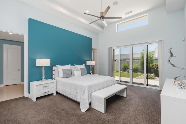 bedroom with access to outside, ceiling fan, a towering ceiling, and dark colored carpet