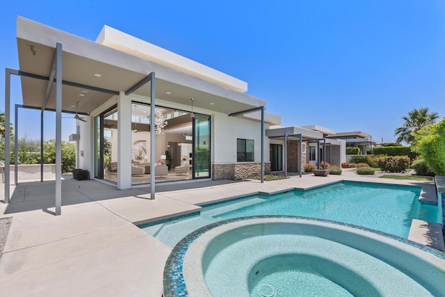 view of swimming pool with an in ground hot tub, a patio, and ceiling fan