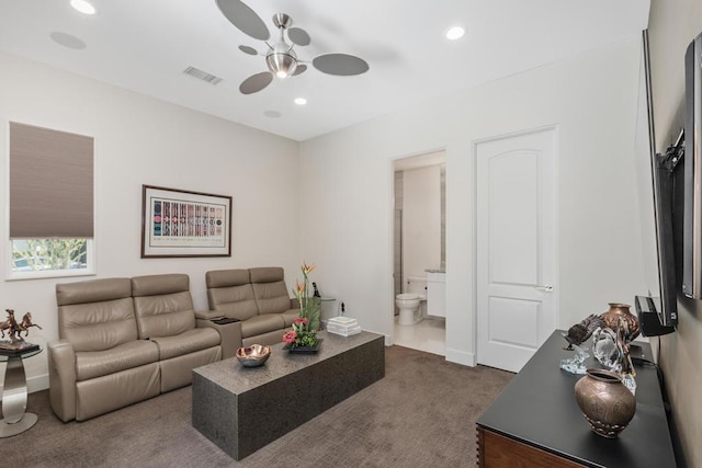 carpeted living room featuring ceiling fan