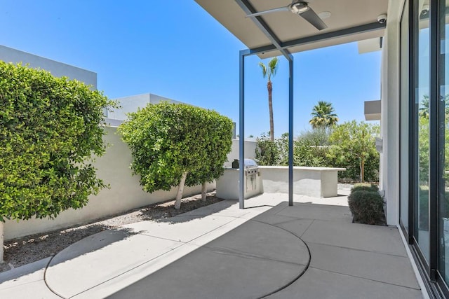 view of patio / terrace featuring an outdoor kitchen and ceiling fan