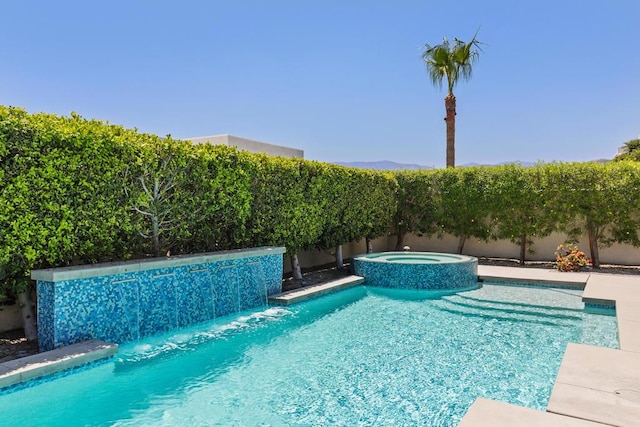 view of pool with pool water feature and an in ground hot tub