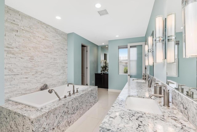 bathroom with vanity, tile patterned floors, and tiled tub