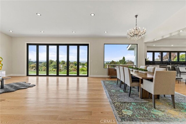 dining room featuring light hardwood / wood-style flooring and an inviting chandelier