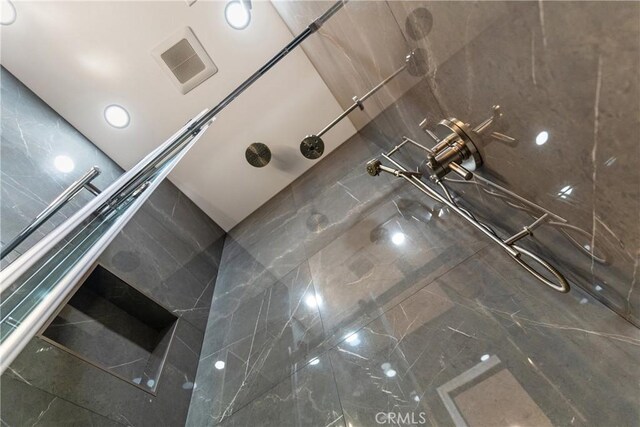 interior space with tile patterned floors and a shower