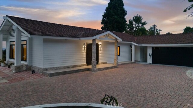 ranch-style home featuring a garage