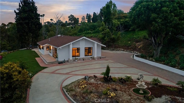 view of front of property with a lawn and driveway