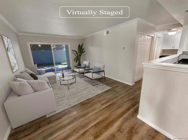 living room with dark hardwood / wood-style flooring and ornamental molding