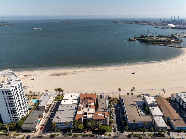 birds eye view of property featuring a beach view and a water view