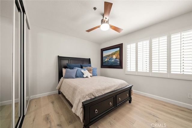 bedroom featuring ceiling fan, light wood-type flooring, and a closet