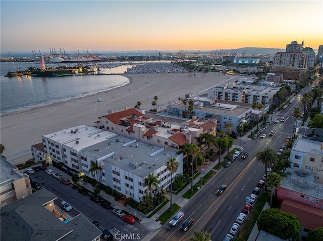 aerial view at dusk featuring a water view