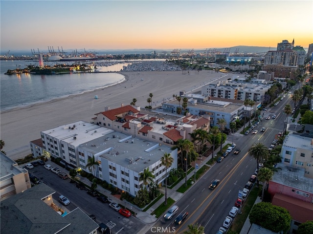 aerial view at dusk with a view of city and a water view