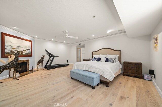 bedroom featuring crown molding, ceiling fan, and light wood-type flooring