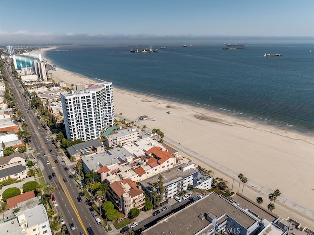 aerial view featuring a water view, a view of city, and a beach view