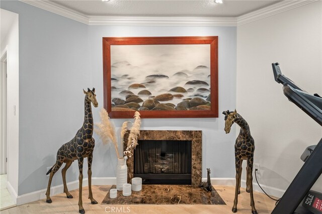 interior space with crown molding and a tile fireplace