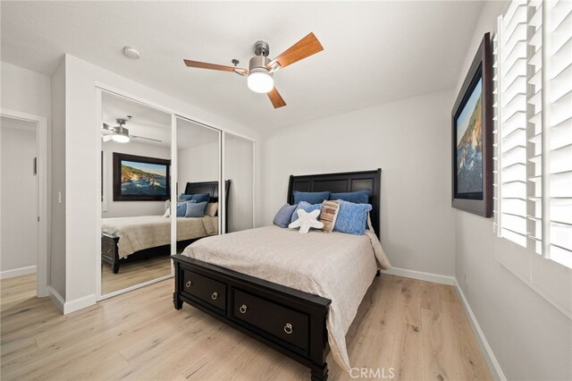 bedroom featuring ceiling fan, a closet, and light hardwood / wood-style flooring