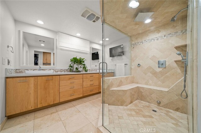 bathroom with tile patterned floors, vanity, and a shower with shower door