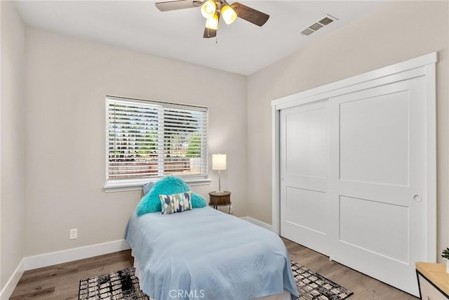 bedroom featuring ceiling fan, a closet, and light wood-type flooring