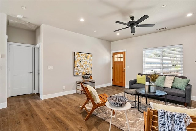 living room with ceiling fan and hardwood / wood-style flooring