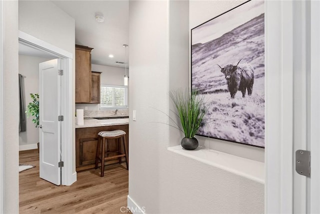 hallway with light hardwood / wood-style floors