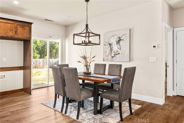 dining room featuring a chandelier and hardwood / wood-style flooring