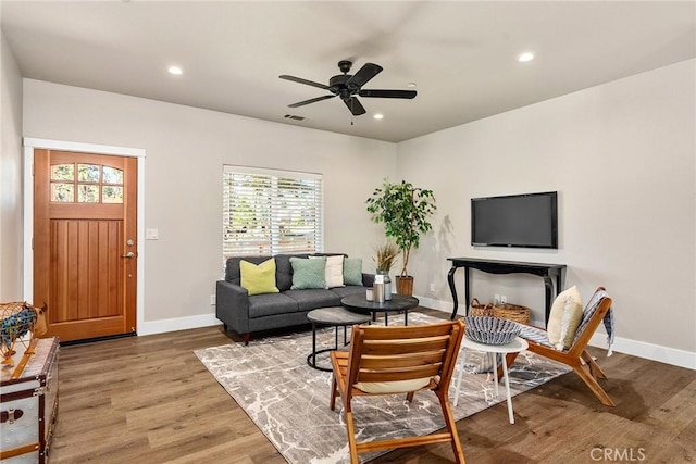 living room with ceiling fan and hardwood / wood-style flooring