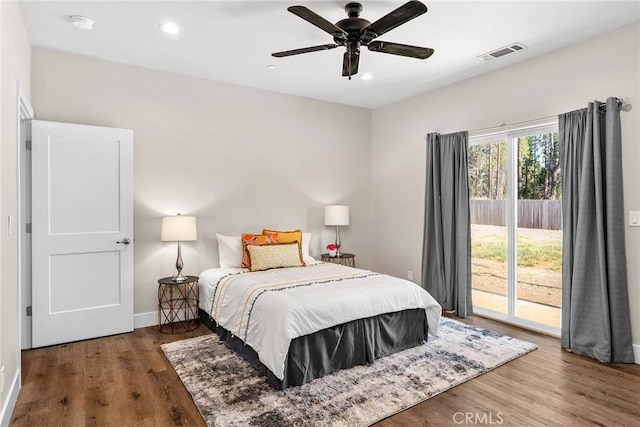 bedroom featuring ceiling fan, access to exterior, and hardwood / wood-style floors